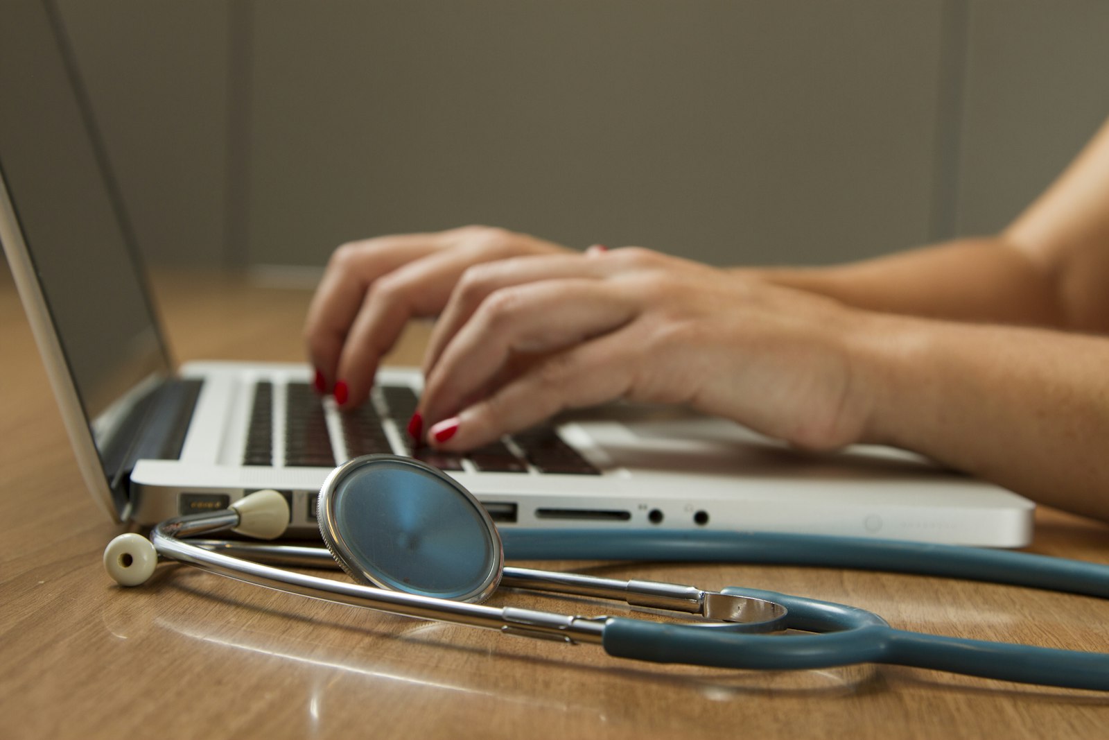 Stethoscope beside a laptop